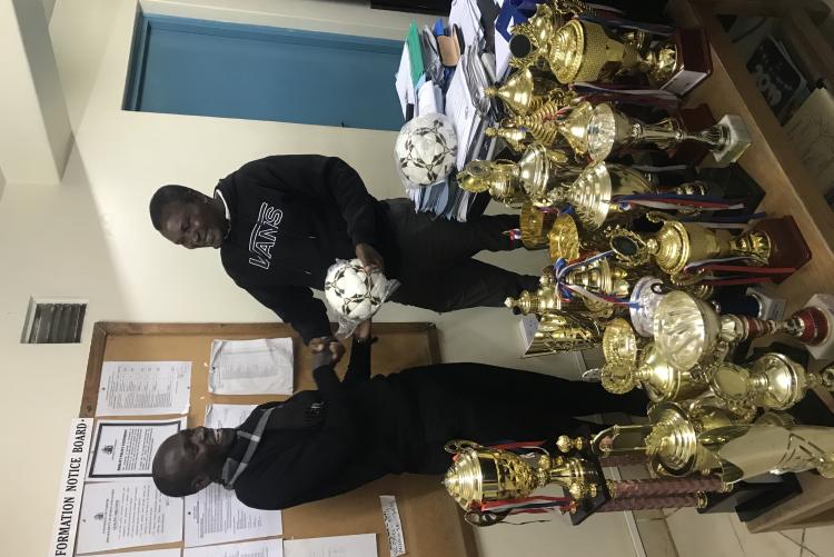 Cleopas Makori an alluminae of University of Nairobi Donating Soccer Balls to the Director Sports and Games